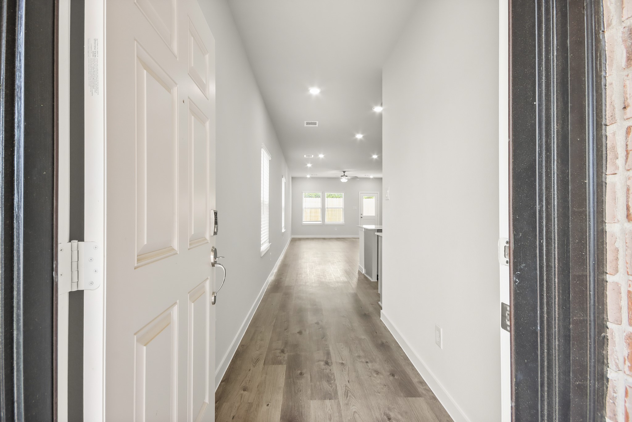 225 Spring Drive Hockley, TX 77447 - Photo 3 of 24 a view of a hallway with wooden floor