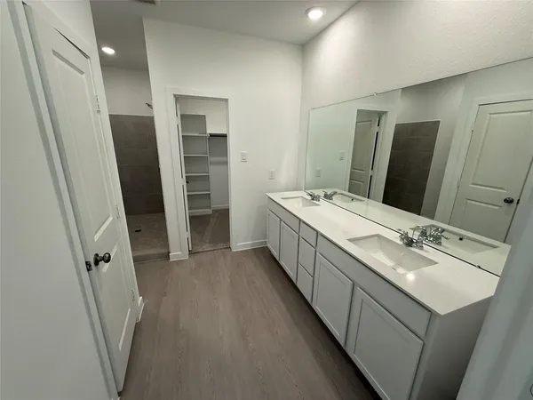 a bathroom with a double vanity sink and mirror