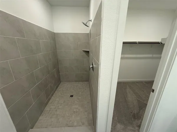 a bathroom with a glass shower door