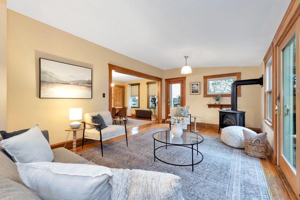 107 Hibbert Street Arlington, MA 02476 - Photo 22 of 40 a living room with furniture and a fireplace