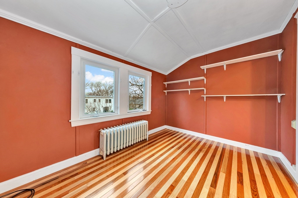 107 Hibbert Street Arlington, MA 02476 - Photo 26 of 40 a view of a room with wooden floor and a window