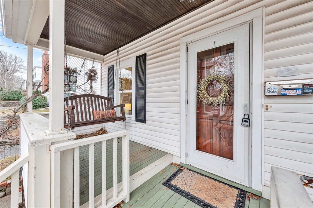 107 Hibbert Street Arlington, MA 02476 - Photo 3 of 40 a view of wooden door with chairs and a gate