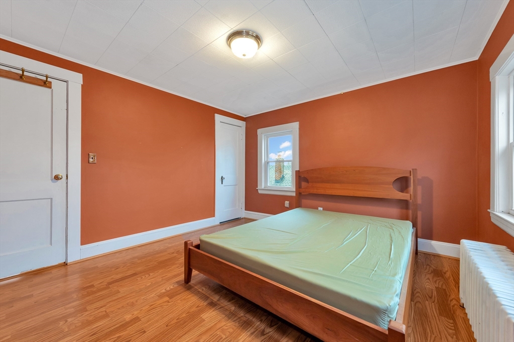107 Hibbert Street Arlington, MA 02476 - Photo 32 of 40 a room with a bed and a mirror