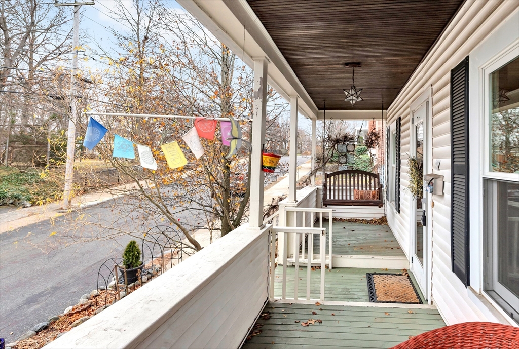 107 Hibbert Street Arlington, MA 02476 - Photo 5 of 40 a view of a balcony with wooden floor and furniture