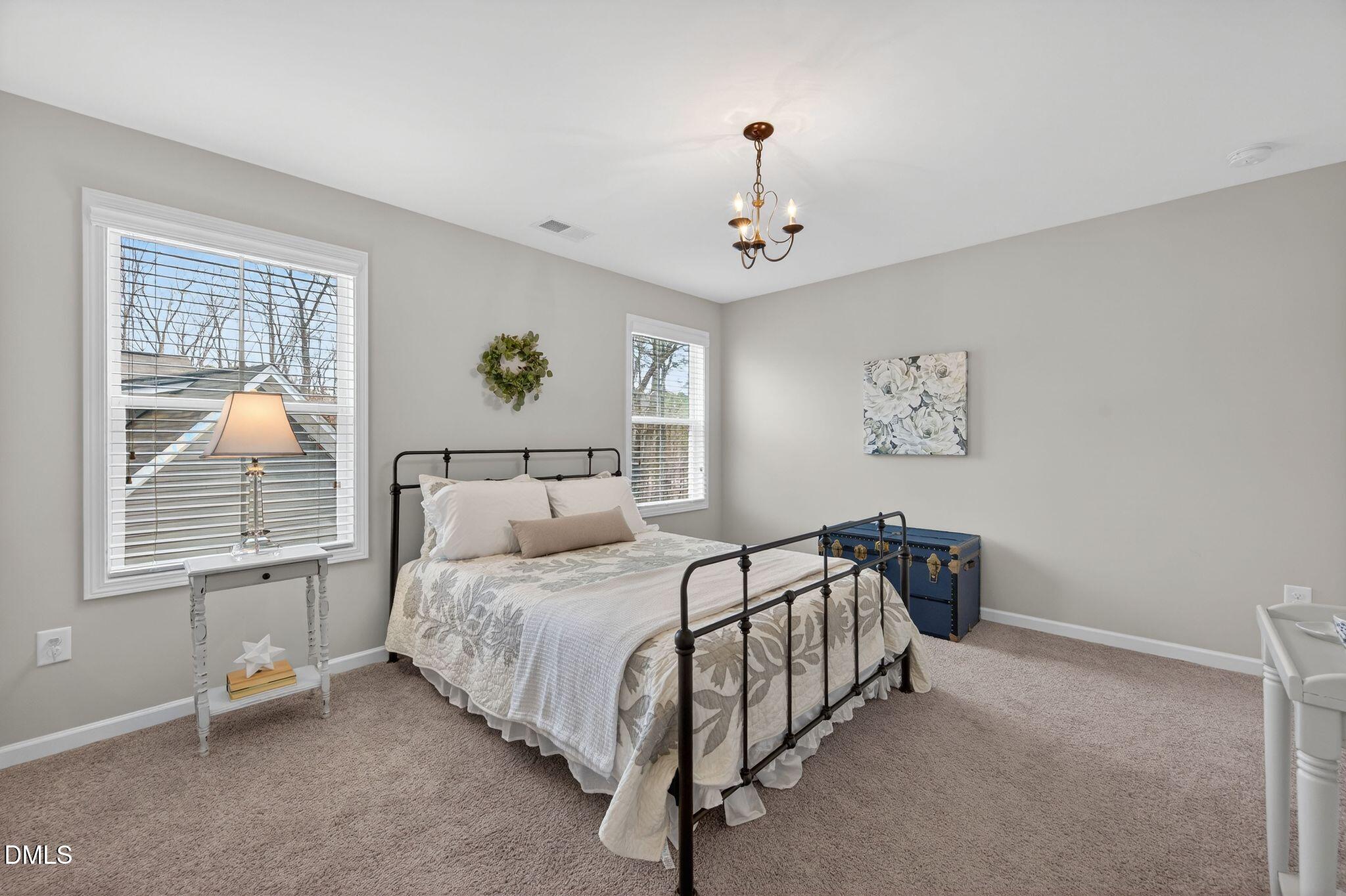 528 Spring Flower Court Cary, NC 27511 - Photo 36 of 51 a bedroom with a bed and a window