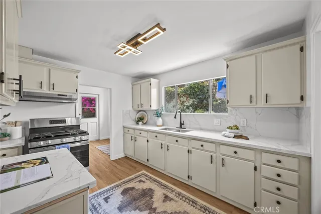 a kitchen with cabinets and window