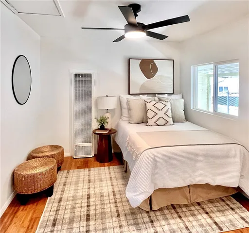 a bedroom with a bed and wooden floor