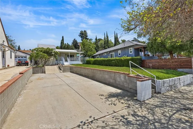 a view of a garden with large trees