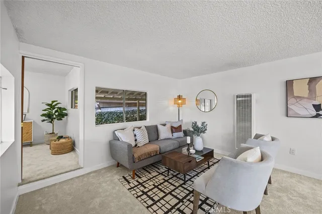 a living room with furniture and a potted plant