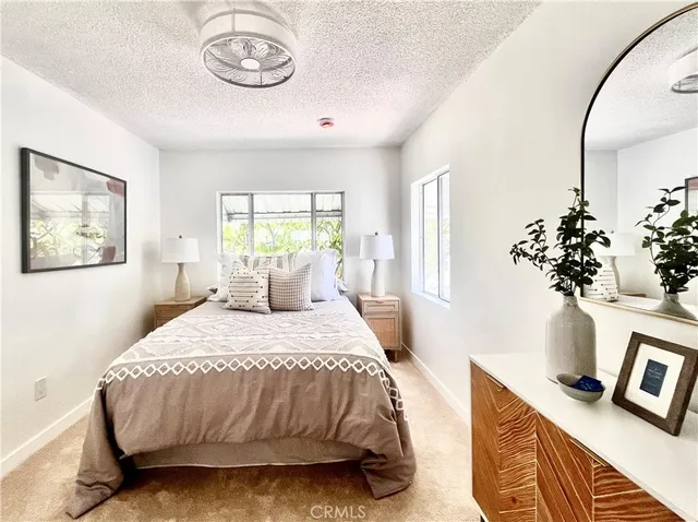 a bedroom with a bed and a table with chair