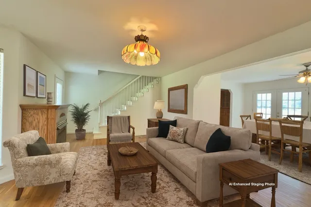 a living room with furniture chandelier and a table