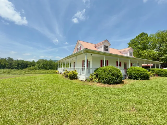 a front view of a house with yard and green space