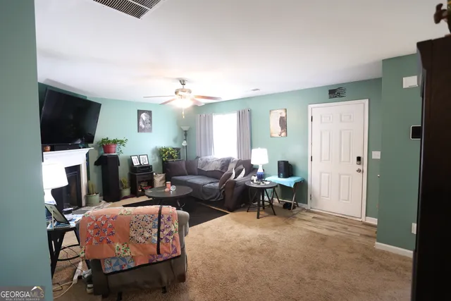 a living room with furniture and a flat screen tv