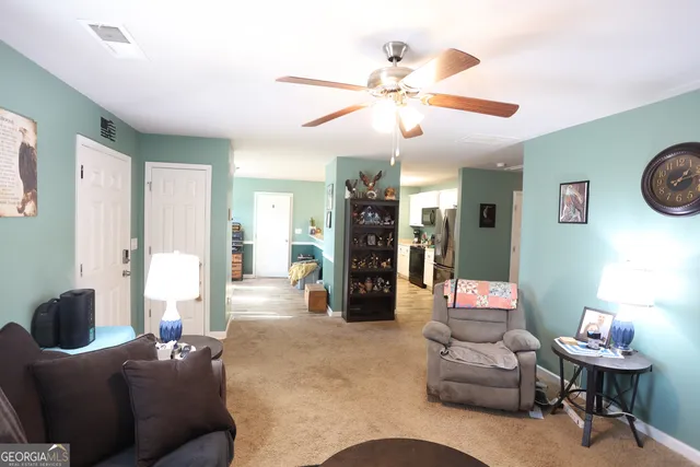 a living room with furniture and a chandelier