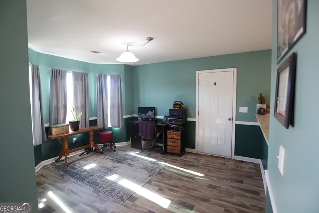 a view of a workspace with furniture and a window