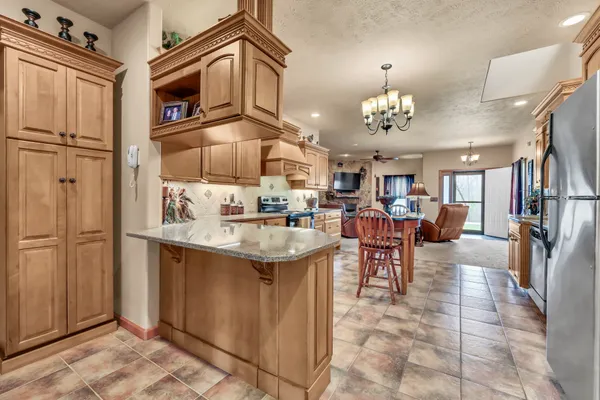 a kitchen with kitchen island a sink appliances and cabinets