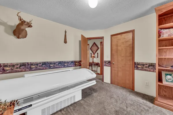 a bedroom with a bed and ceiling fan