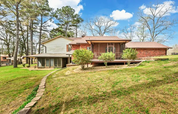 a front view of house with yard and trees