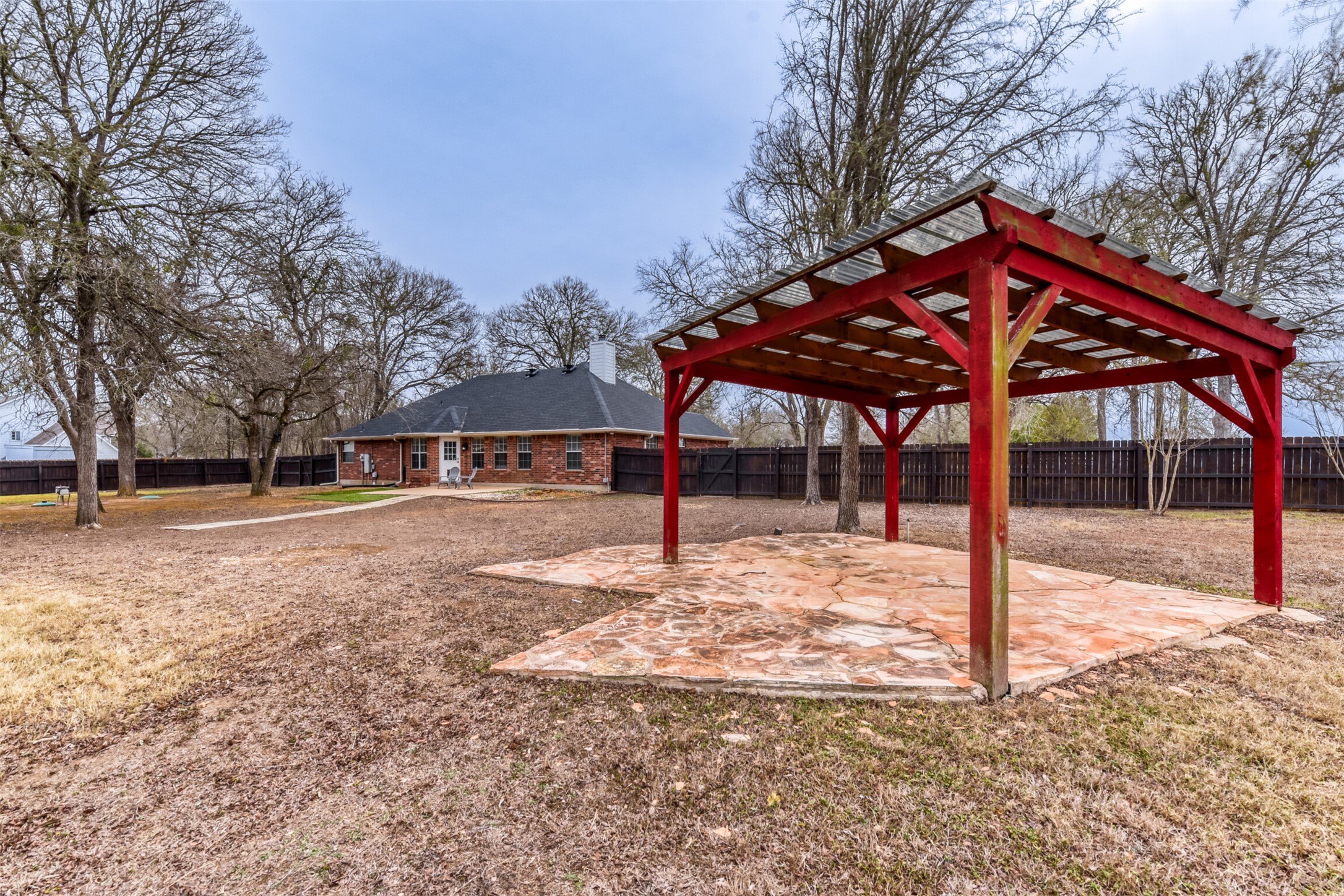 104 Spring Branch Bastrop, TX 78602 - Photo 27 of 32 a view of a house with backyard and trees