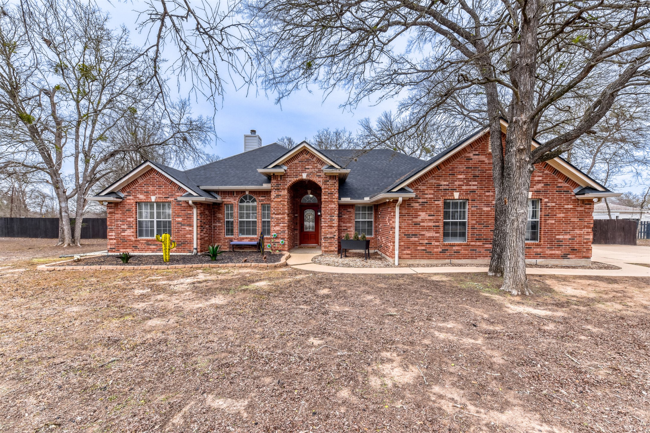 104 Spring Branch Bastrop, TX 78602 - Photo 3 of 32 a front view of a house with a yard covered in snow