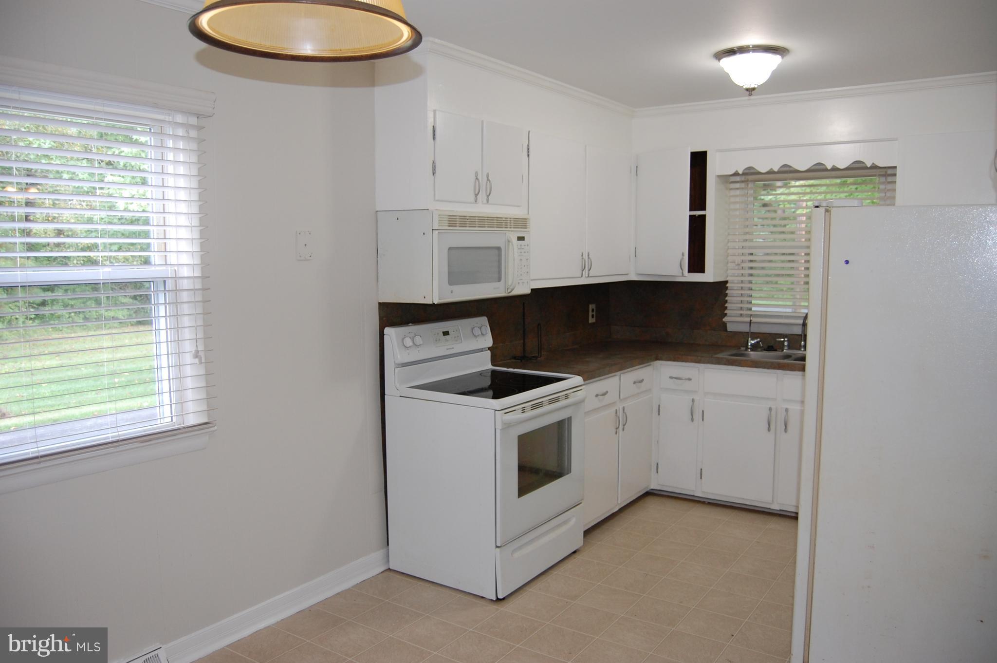 5848 Nebo Road Quantico, MD 21856 - Photo 8 of 25 a kitchen with a stove cabinets and a window