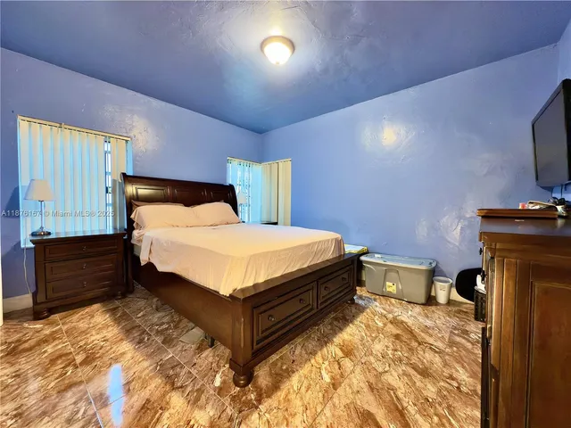 a bedroom with a bed and dresser