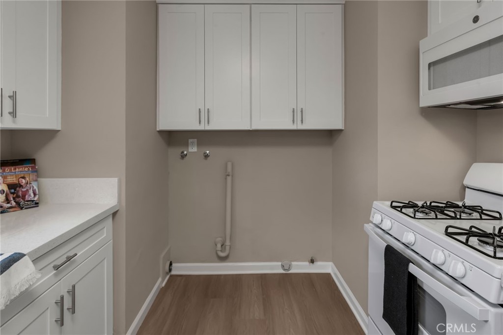 217 East 221st Street Carson, CA 90745 - Photo 16 of 73 a kitchen with a sink and a stove top oven
