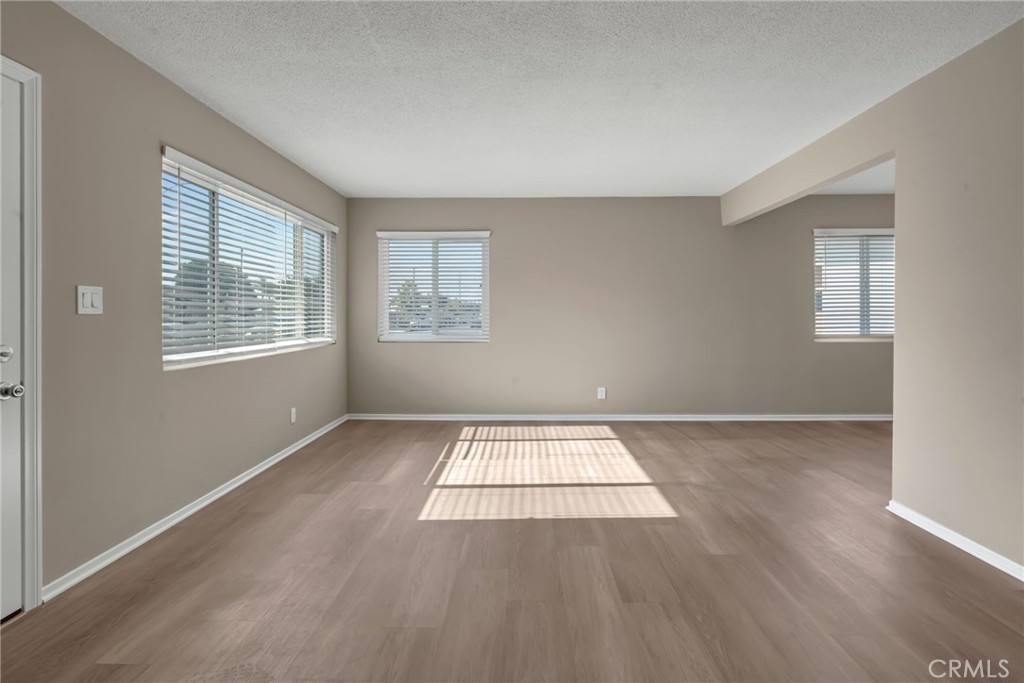 217 East 221st Street Carson, CA 90745 - Photo 34 of 73 an empty room with wooden floor and windows