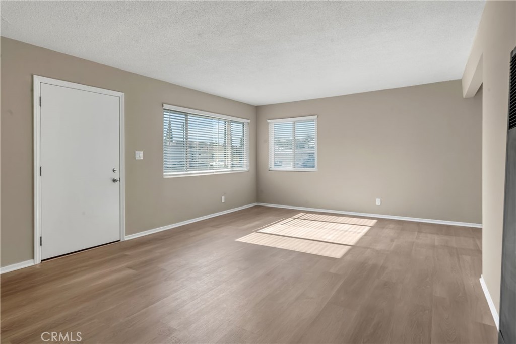 217 East 221st Street Carson, CA 90745 - Photo 35 of 73 an empty room with wooden floor and windows