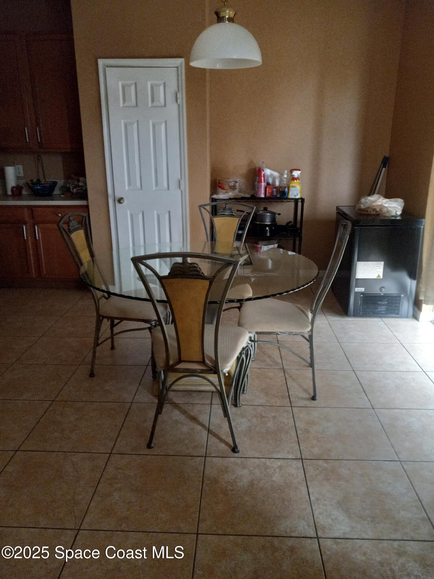 561 Lambert Street Southwest Palm Bay, FL 32908 - Photo 3 of 10 a view of a dining room with furniture and a potted plant