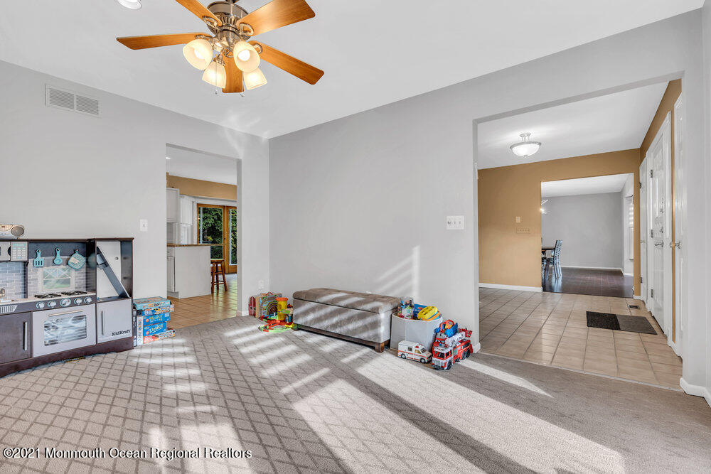 67 Chelsea Road Jackson, NJ 08527 - Photo 12 of 53 a bedroom with a bed and a chandelier