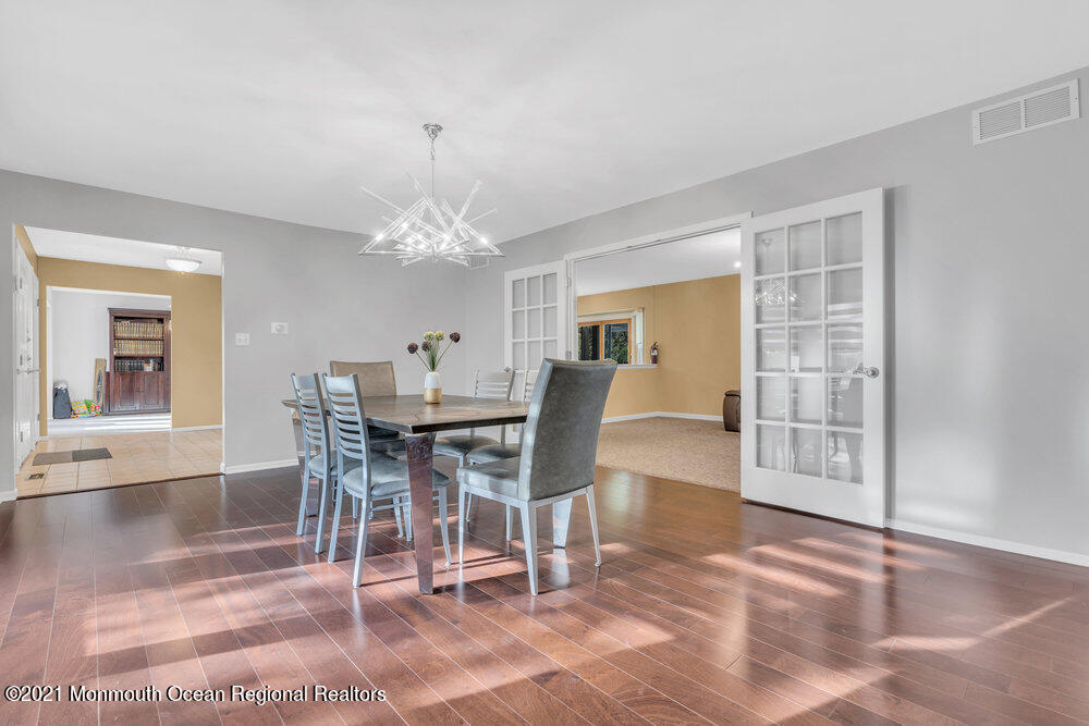 67 Chelsea Road Jackson, NJ 08527 - Photo 15 of 53 a dining room with wooden floor and chandelier