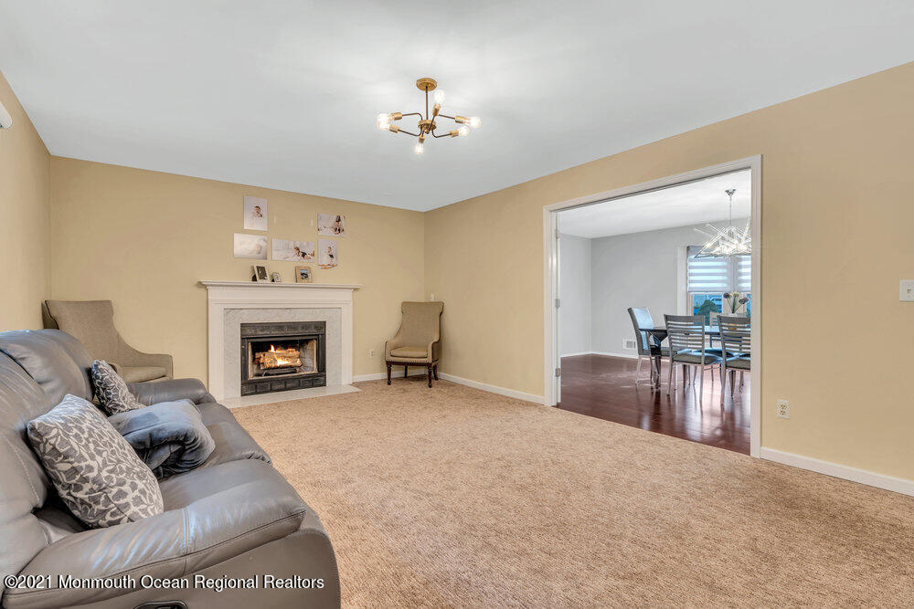 67 Chelsea Road Jackson, NJ 08527 - Photo 19 of 53 a living room with furniture and a fireplace