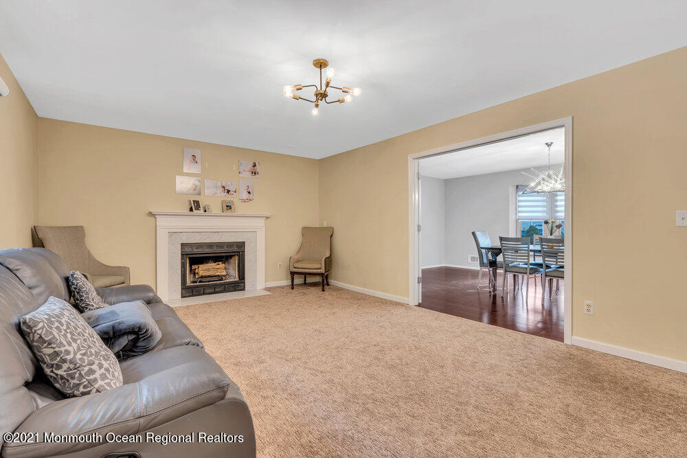 67 Chelsea Road Jackson, NJ 08527 - Photo 20 of 53 a living room with furniture and a fireplace