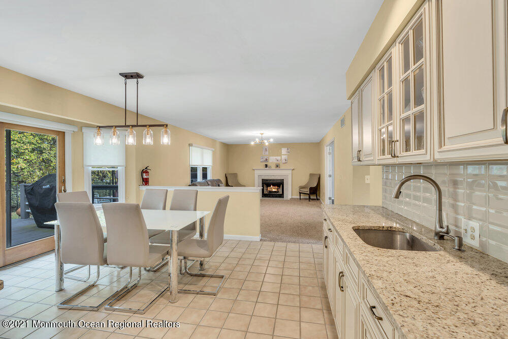 67 Chelsea Road Jackson, NJ 08527 - Photo 22 of 53 a view of a kitchen with a dining table chairs and a wooden floor