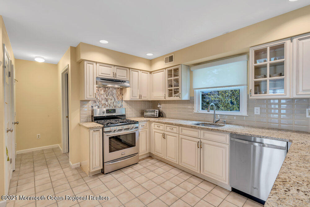 67 Chelsea Road Jackson, NJ 08527 - Photo 24 of 53 a kitchen with a sink stove and cabinets