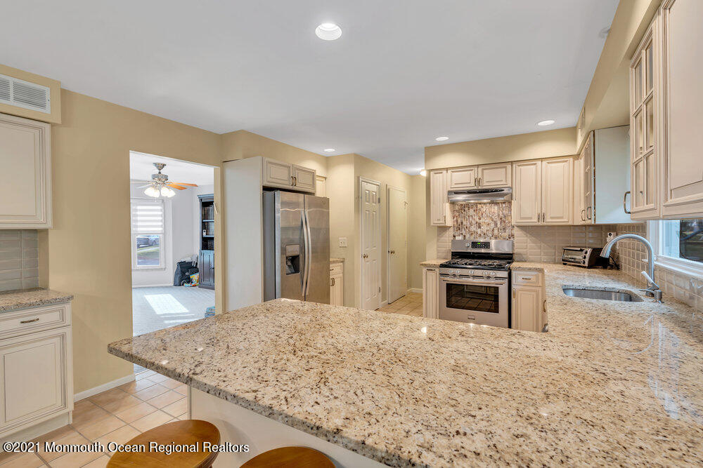 67 Chelsea Road Jackson, NJ 08527 - Photo 25 of 53 a kitchen with stainless steel appliances granite countertop a sink stove and refrigerator