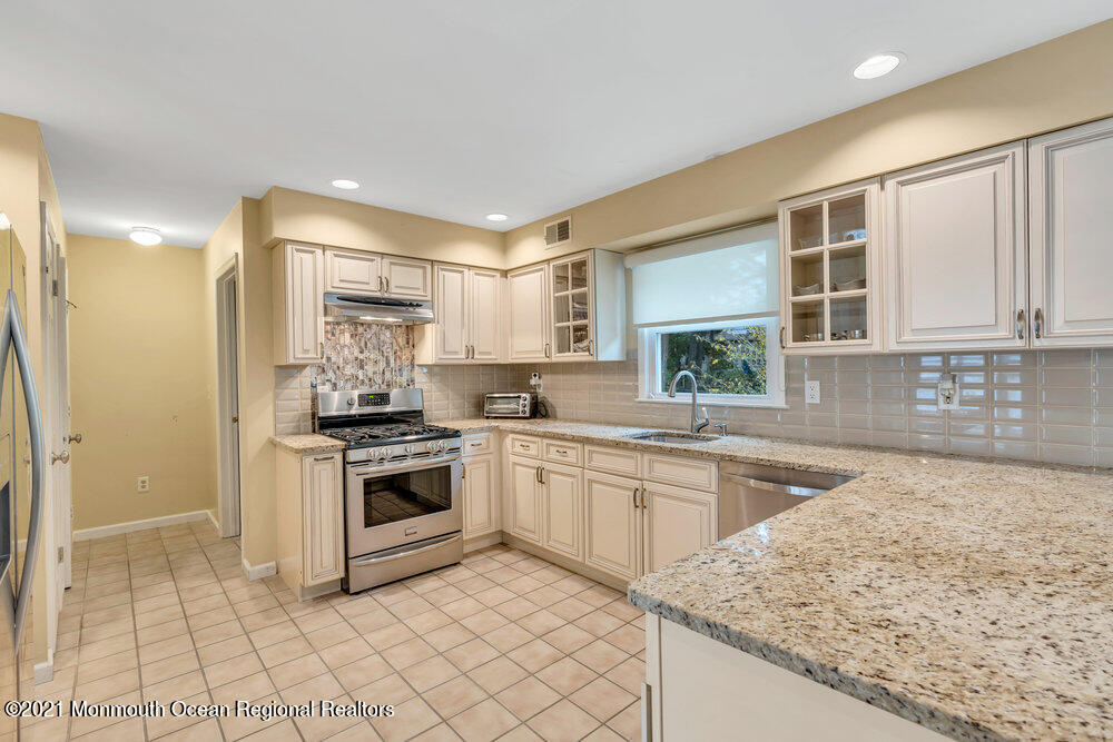67 Chelsea Road Jackson, NJ 08527 - Photo 26 of 53 a kitchen with stainless steel appliances granite countertop a stove a sink and a microwave
