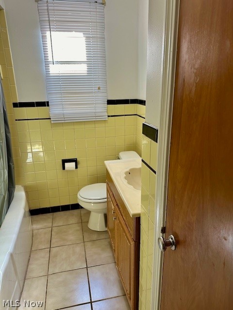 751 Thayer Street, Unit DOWN Akron, OH 44310 - Photo 16 of 25 Full bathroom with tile walls, tile patterned floors, vanity, and toilet
