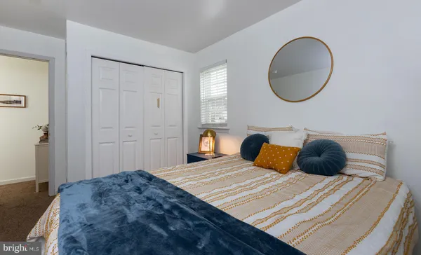 a bedroom with a large bed and a wooden floor
