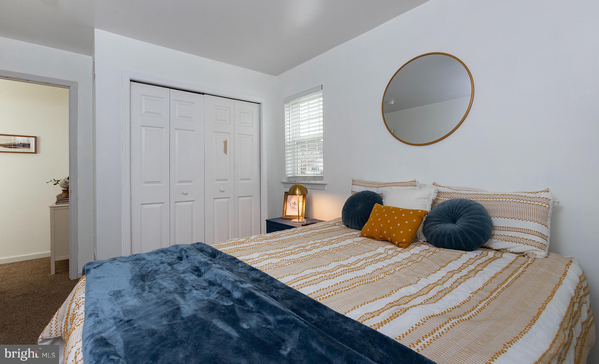 606 Butterfly Circle Dallastown, PA 17313 - Photo 15 of 40 a bedroom with a large bed and a wooden floor