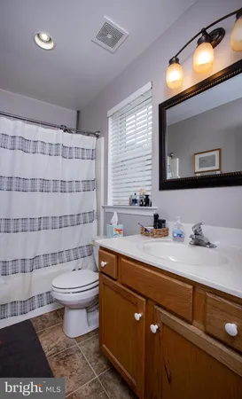 a bathroom with a sink toilet a mirror and a shower