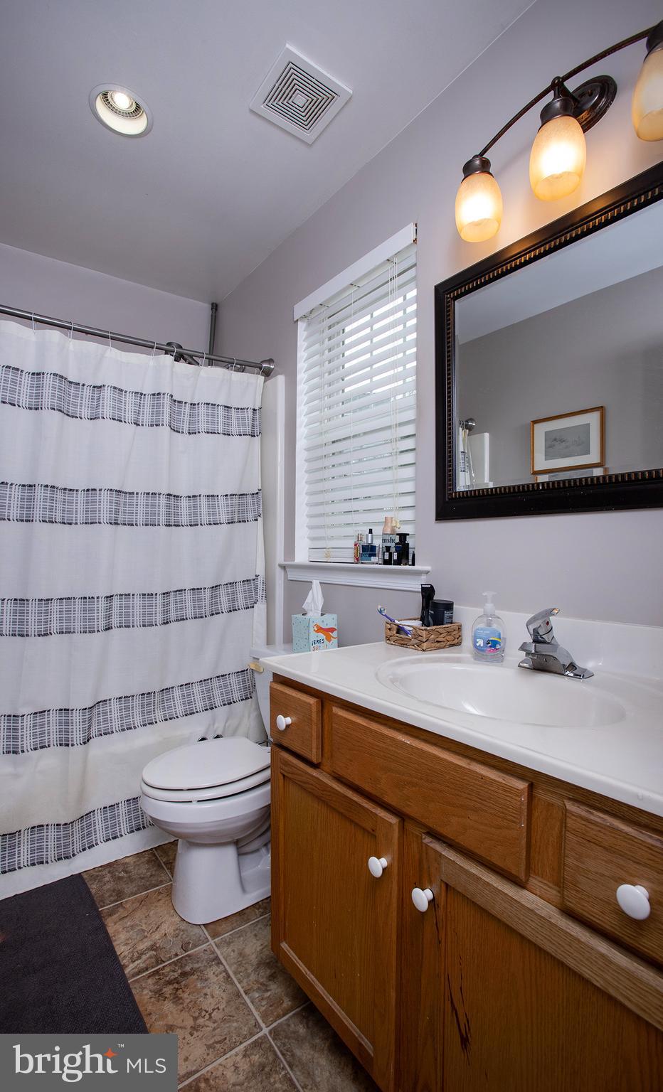 606 Butterfly Circle Dallastown, PA 17313 - Photo 19 of 40 a bathroom with a sink toilet a mirror and a shower