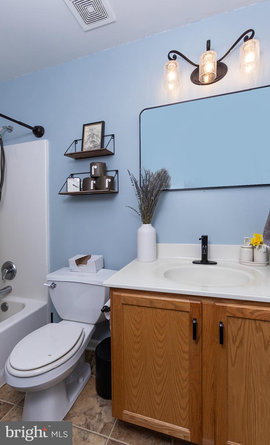 606 Butterfly Circle Dallastown, PA 17313 - Photo 22 of 40 a bathroom with a granite countertop sink a toilet and a mirror