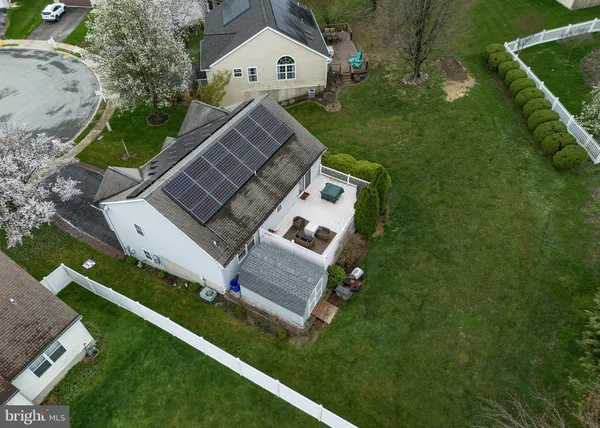 an aerial view of a house with a yard