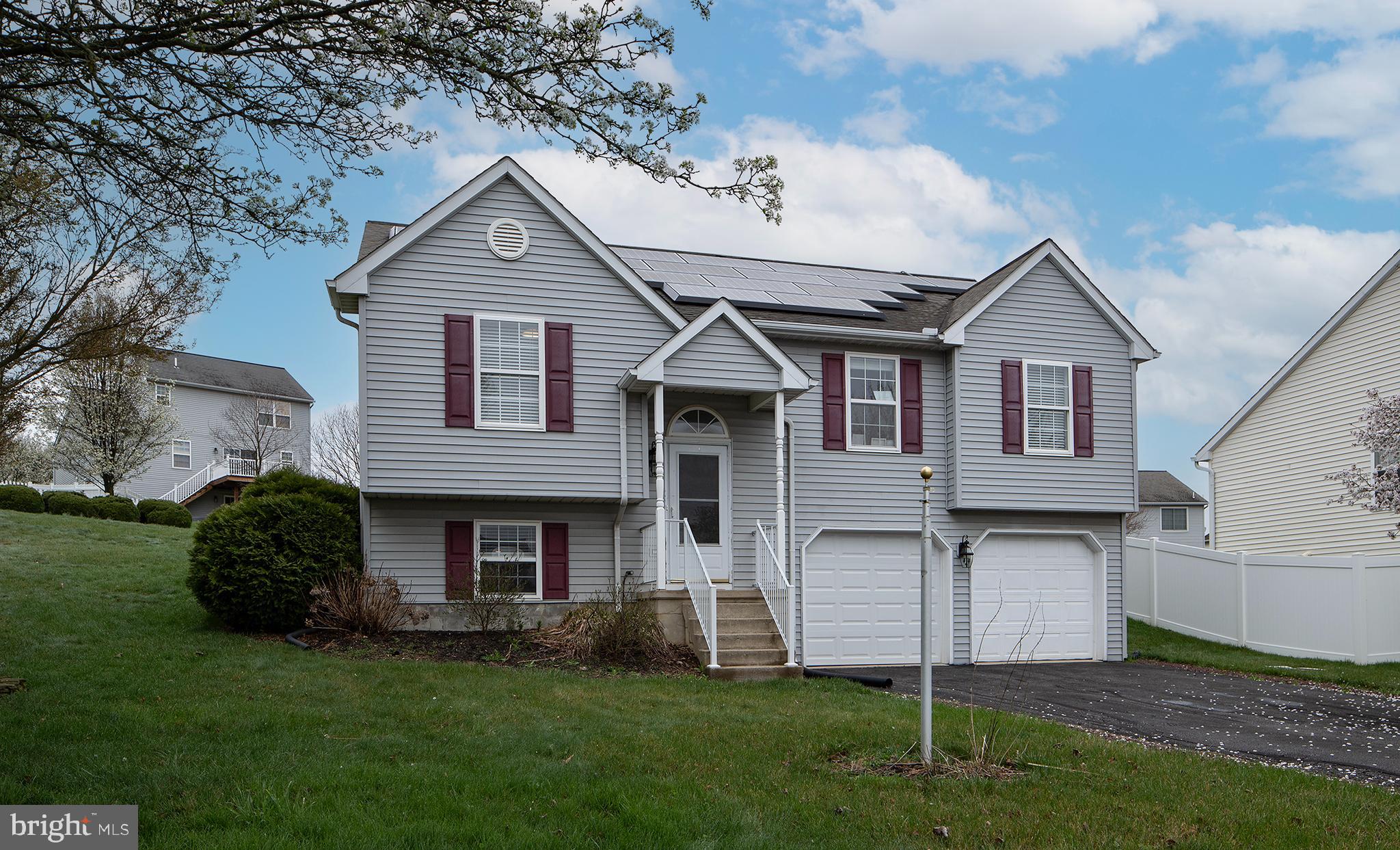 606 Butterfly Circle Dallastown, PA 17313 - Photo 37 of 40 a front view of a house with a garden and plants