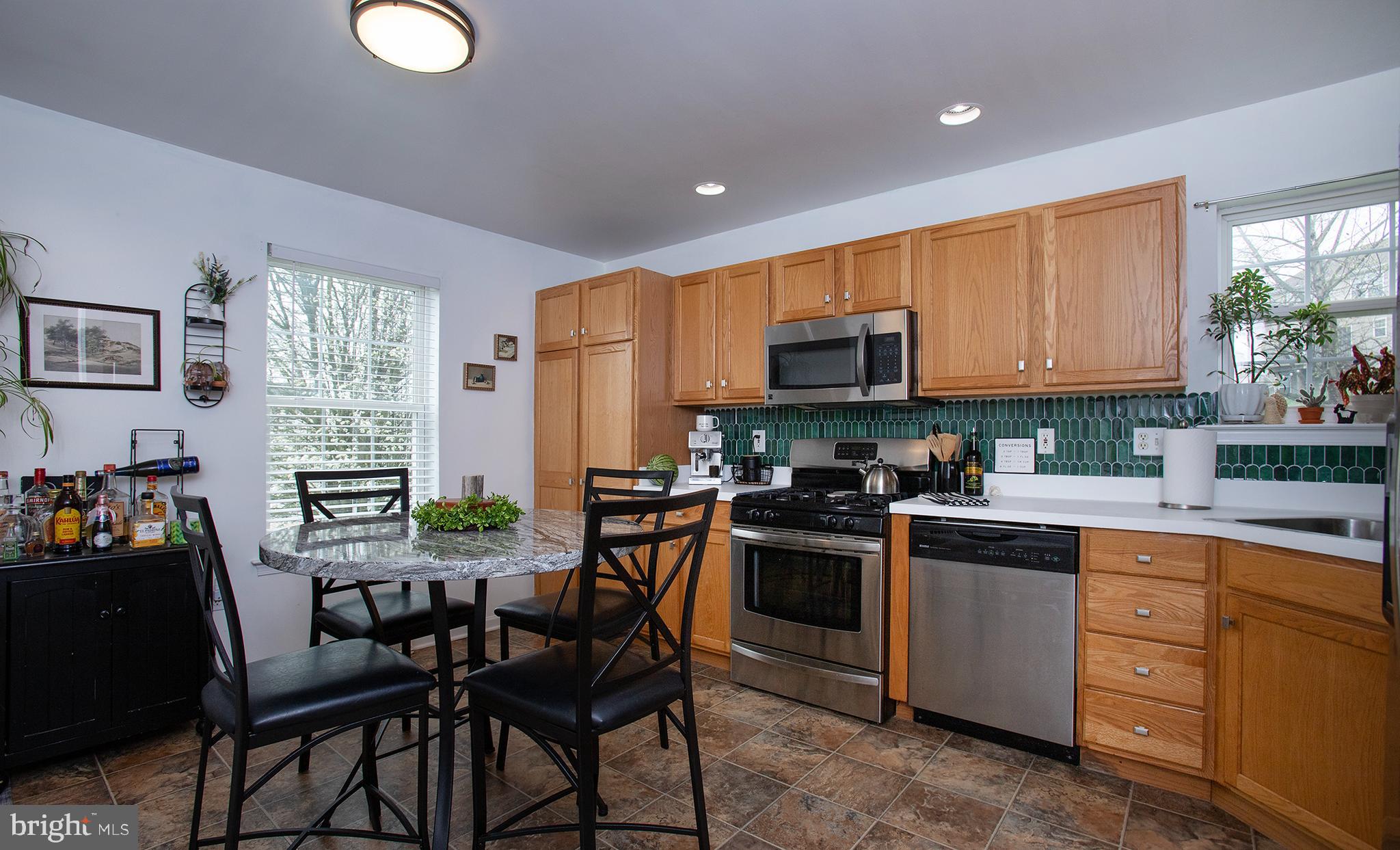 606 Butterfly Circle Dallastown, PA 17313 - Photo 8 of 40 a kitchen with a table chairs microwave and cabinets