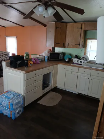 a kitchen with kitchen island a sink stainless steel appliances and cabinets