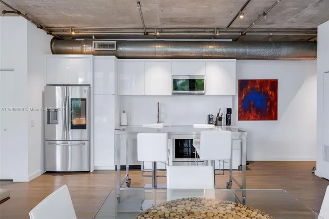 a living room with furniture and kitchen view