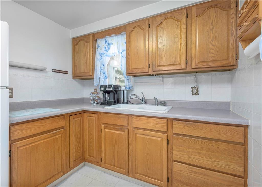 115 Rockwood Street Monroeville, PA 15146 - Photo 21 of 32 a kitchen with white cabinets and a sink